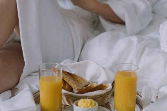 Experience a luxurious morning with breakfast in bed, featuring fresh orange juice and toast.